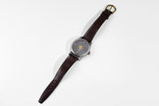 Todd Reed watch made with 18k yellow gold, sterling silver and stainless steel on a leather strap